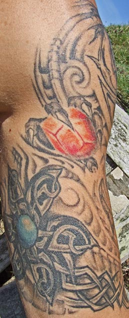 Hell imagery tattoo on man's arm