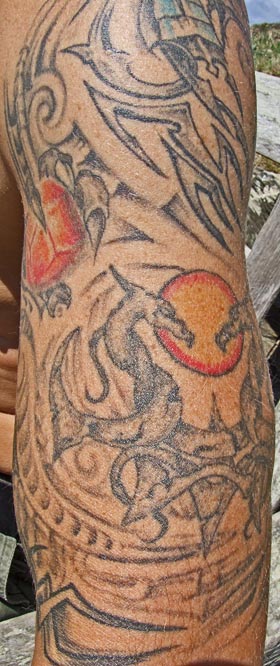 Hell imagery tattoo on man's arm