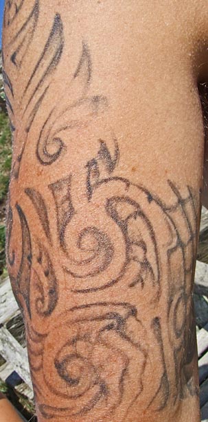 Hell imagery tattoo on man's arm