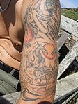 Night hell tatoos on man's arm